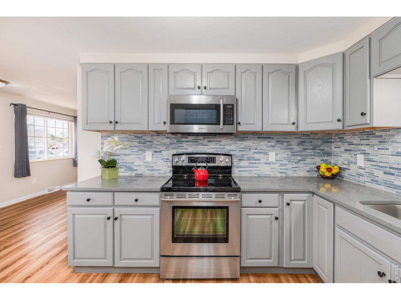 439 Dickson Street Longmont, CO 80504 - Photo 17 of 31 a kitchen with stainless steel appliances granite countertop a stove and a microwave