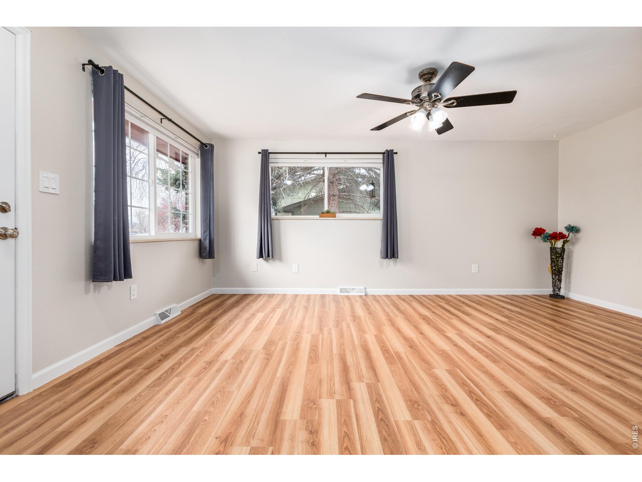 439 Dickson Street Longmont, CO 80504 - Photo 5 of 31 a view of empty room with wooden floor and fan
