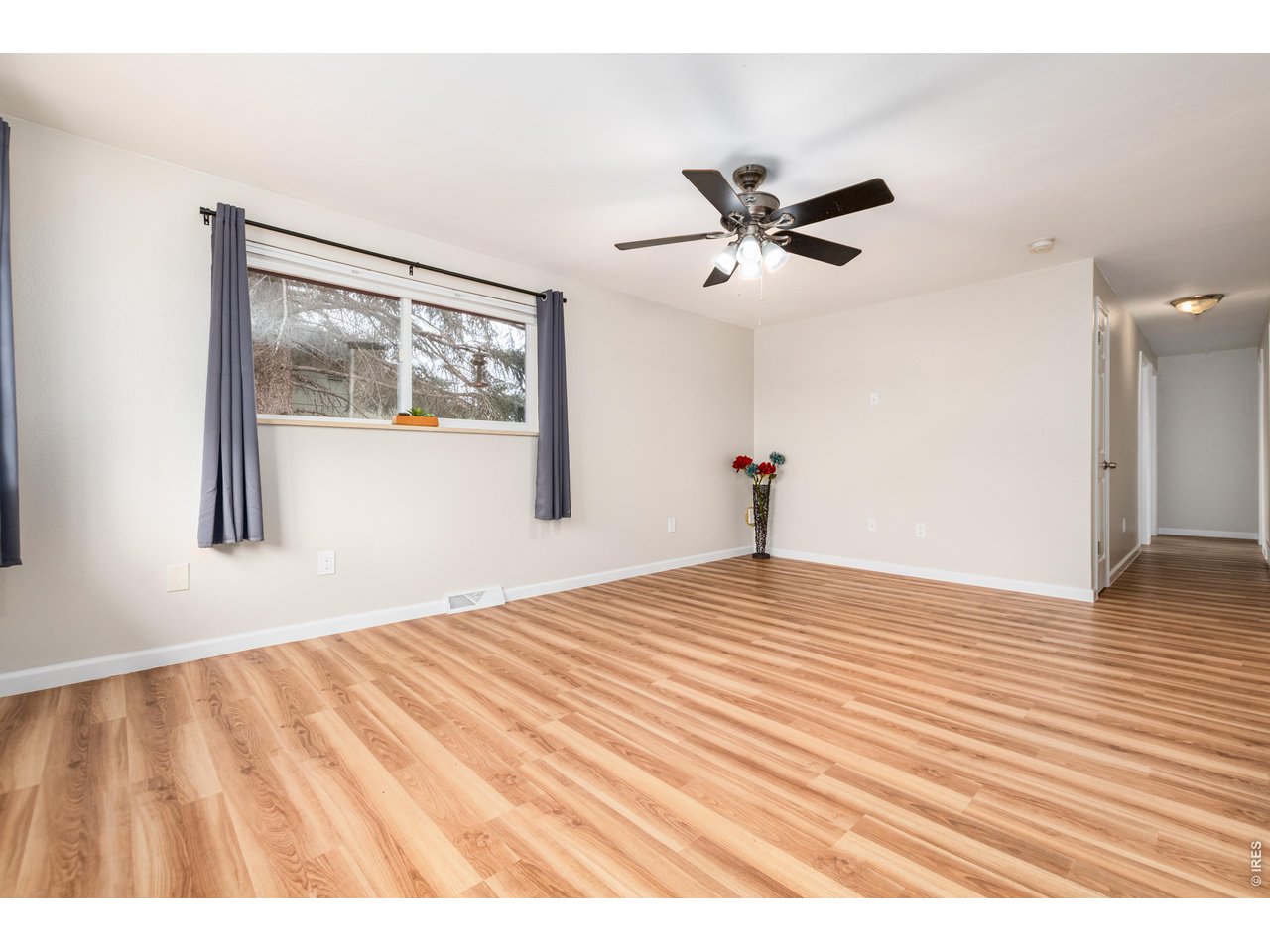 439 Dickson Street Longmont, CO 80504 - Photo 6 of 31 a view of empty room with wooden floor and fan