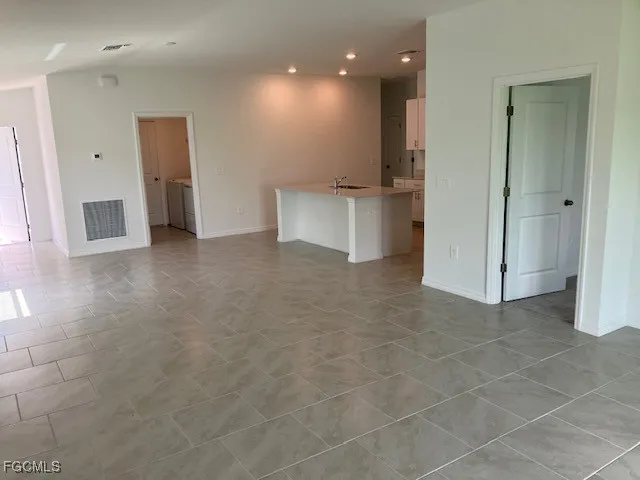 a view of an empty room with a window and closet