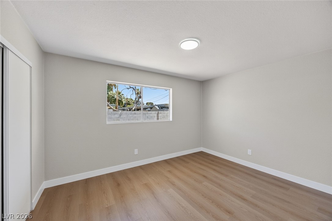 2484 Anglia Street Las Vegas, NV 89142 - Photo 13 of 20 This bright bedroom features durable flooring and ample natural light, creating a welcoming atmosphere.