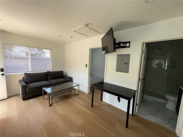 a living room with furniture a rug and white walls