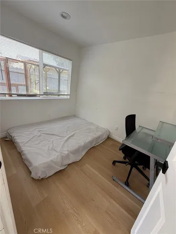 a bedroom with a bed and a desk