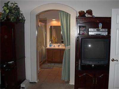 8437 Red Rock Ridge Court Tucson, AZ 85742 - Photo 7 of 10 a bathroom with a sink a light fixture and a mirror