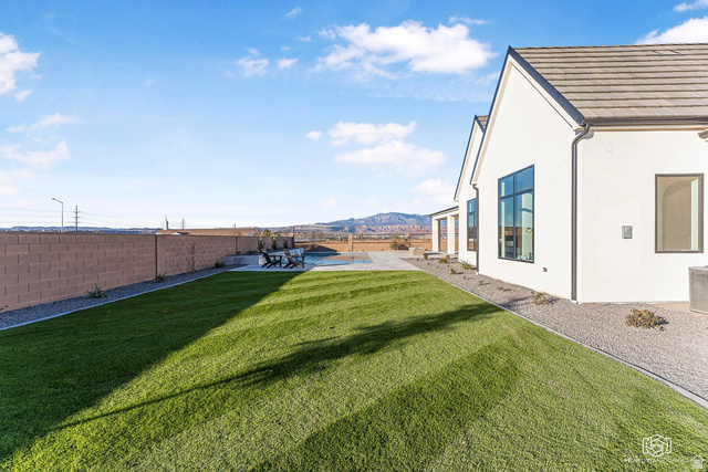 1468 South Red Cliffs Temple Lane St. George, UT 84790 - Photo 59 of 64 Fenced backyard featuring a mountain view, a patio, and a pool