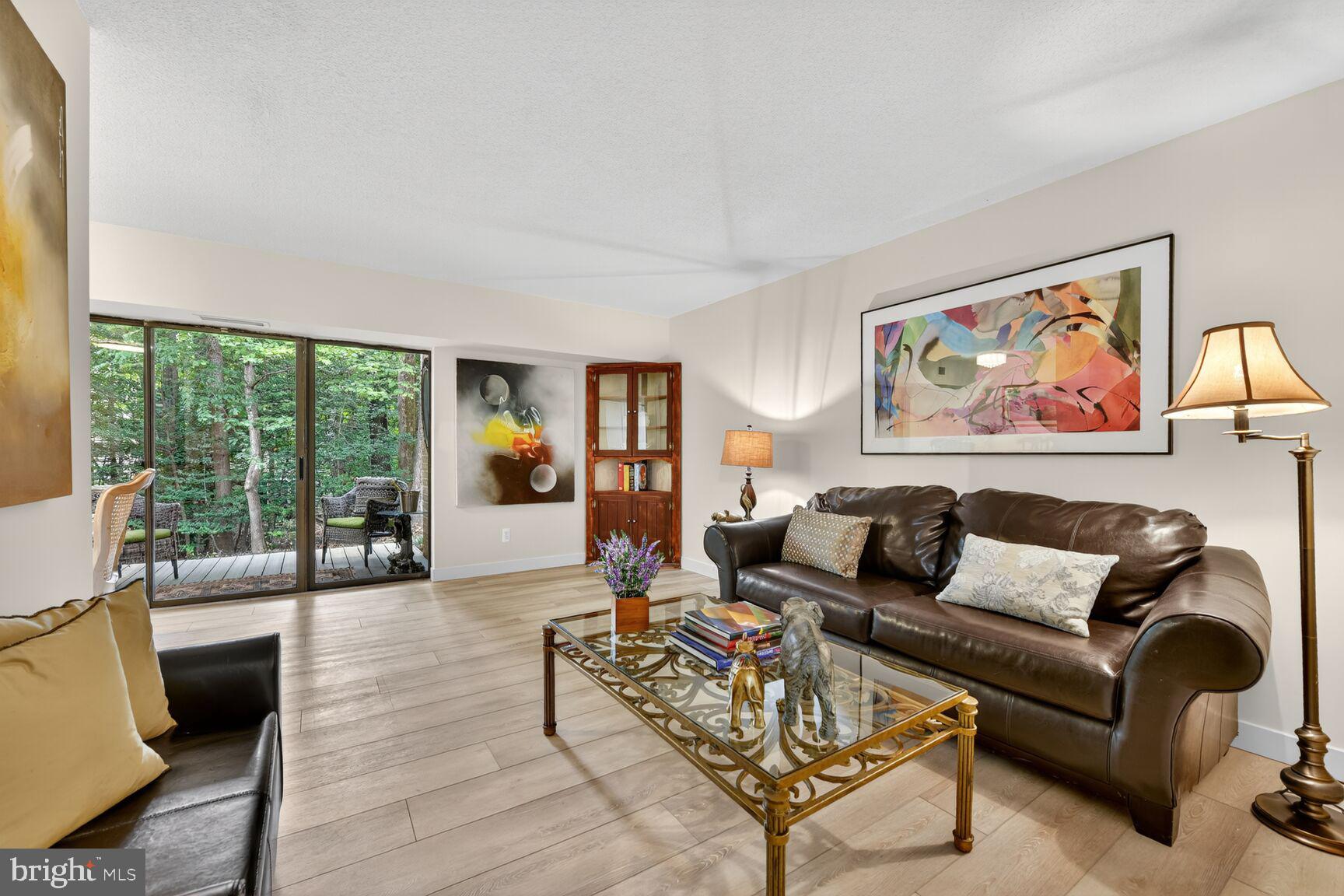 2208 Castle Rock Square, Unit 2B Reston, VA 20191 - Photo 1 of 51 a living room with furniture and a large window