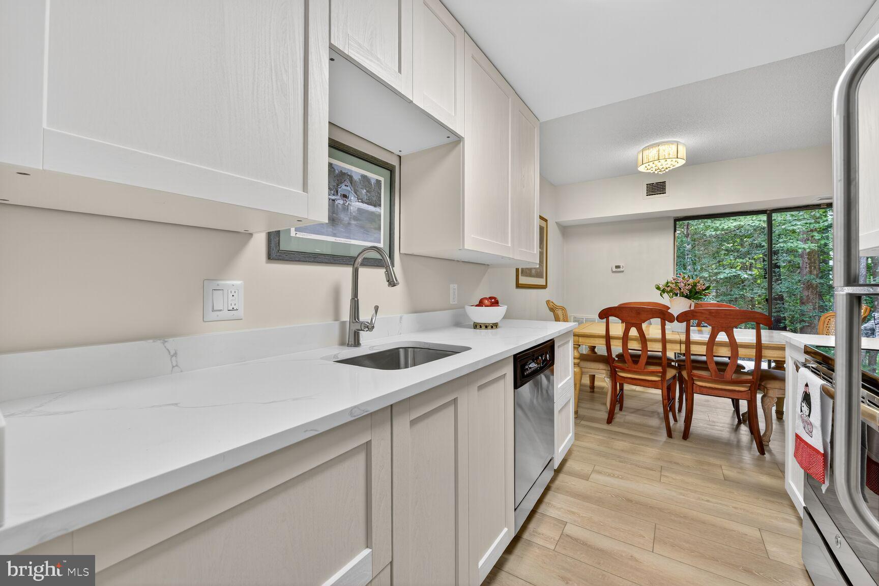 2208 Castle Rock Square, Unit 2B Reston, VA 20191 - Photo 11 of 51 a kitchen with stainless steel appliances a sink a stove and a refrigerator