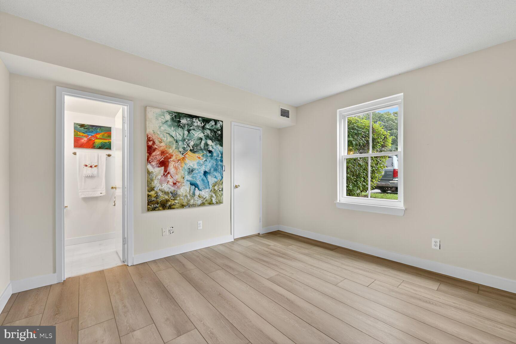 2208 Castle Rock Square, Unit 2B Reston, VA 20191 - Photo 15 of 51 wooden floor in an empty room with a window