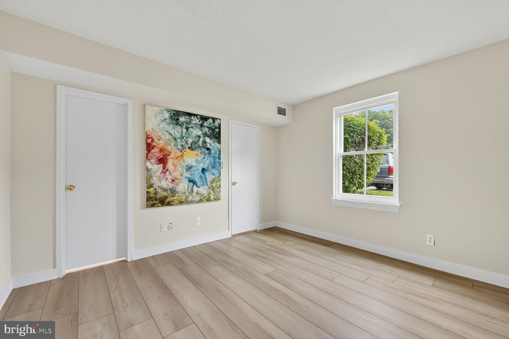 2208 Castle Rock Square, Unit 2B Reston, VA 20191 - Photo 16 of 51 an empty room with wooden floor and window