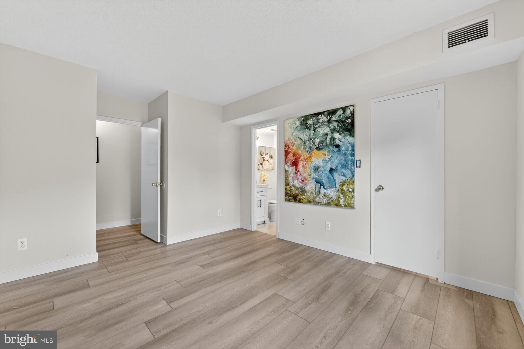2208 Castle Rock Square, Unit 2B Reston, VA 20191 - Photo 17 of 51 an empty room with wooden floor and window
