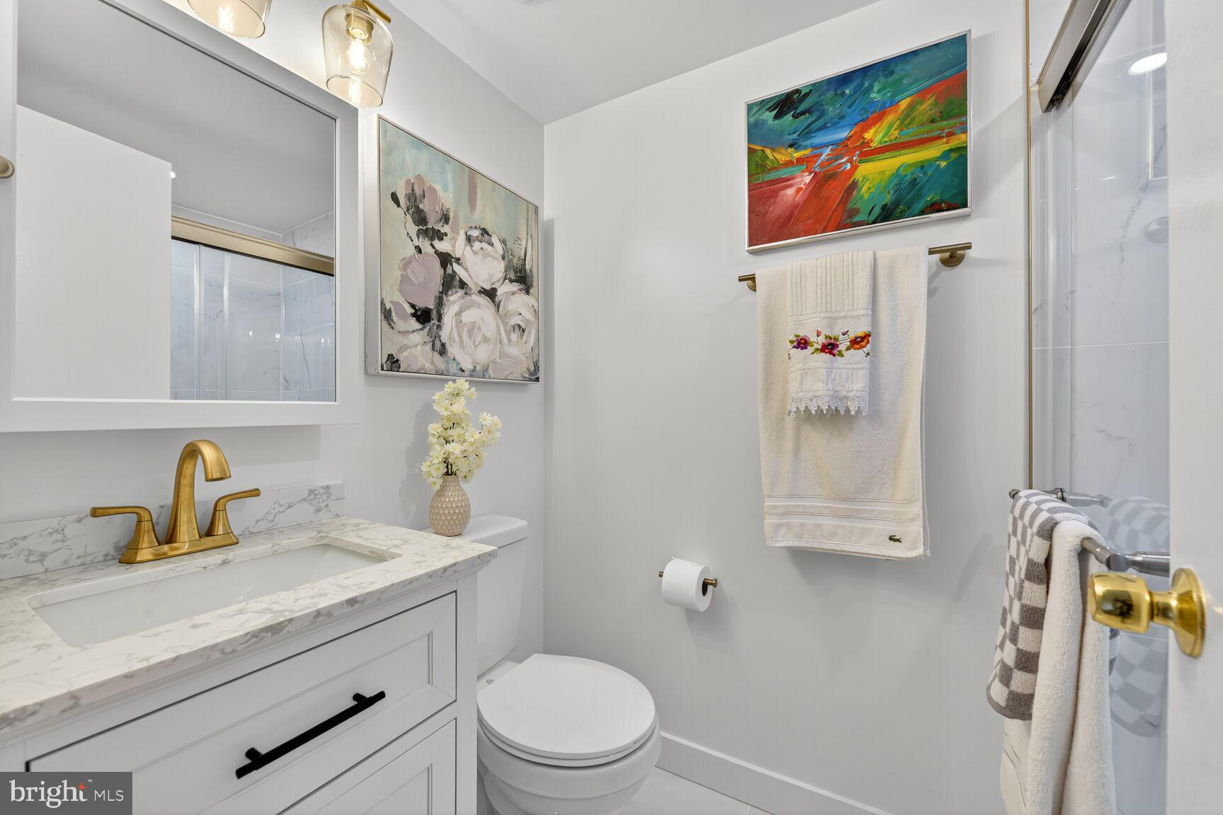 2208 Castle Rock Square, Unit 2B Reston, VA 20191 - Photo 23 of 51 a bathroom with a granite countertop sink mirror vanity and toilet