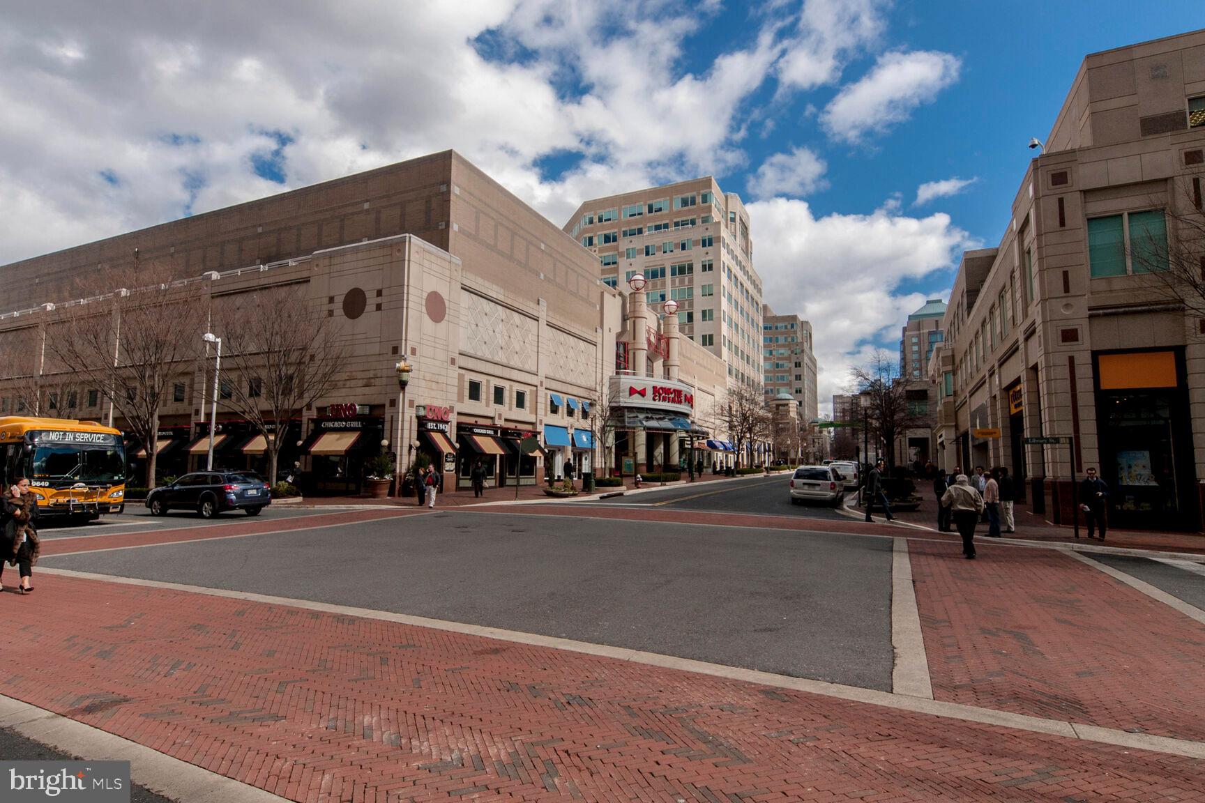 2208 Castle Rock Square, Unit 2B Reston, VA 20191 - Photo 45 of 51 a city street lined with buildings and cars