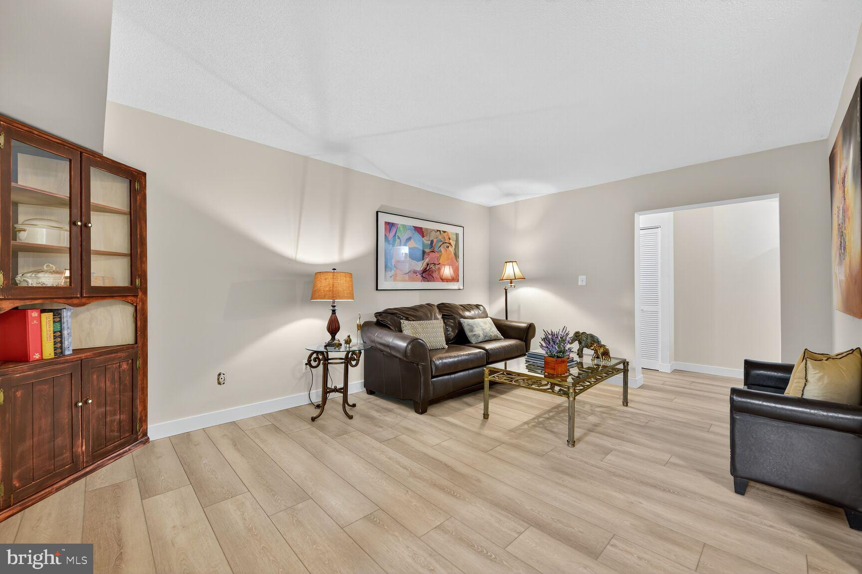 2208 Castle Rock Square, Unit 2B Reston, VA 20191 - Photo 6 of 51 a living room with furniture and wooden floor