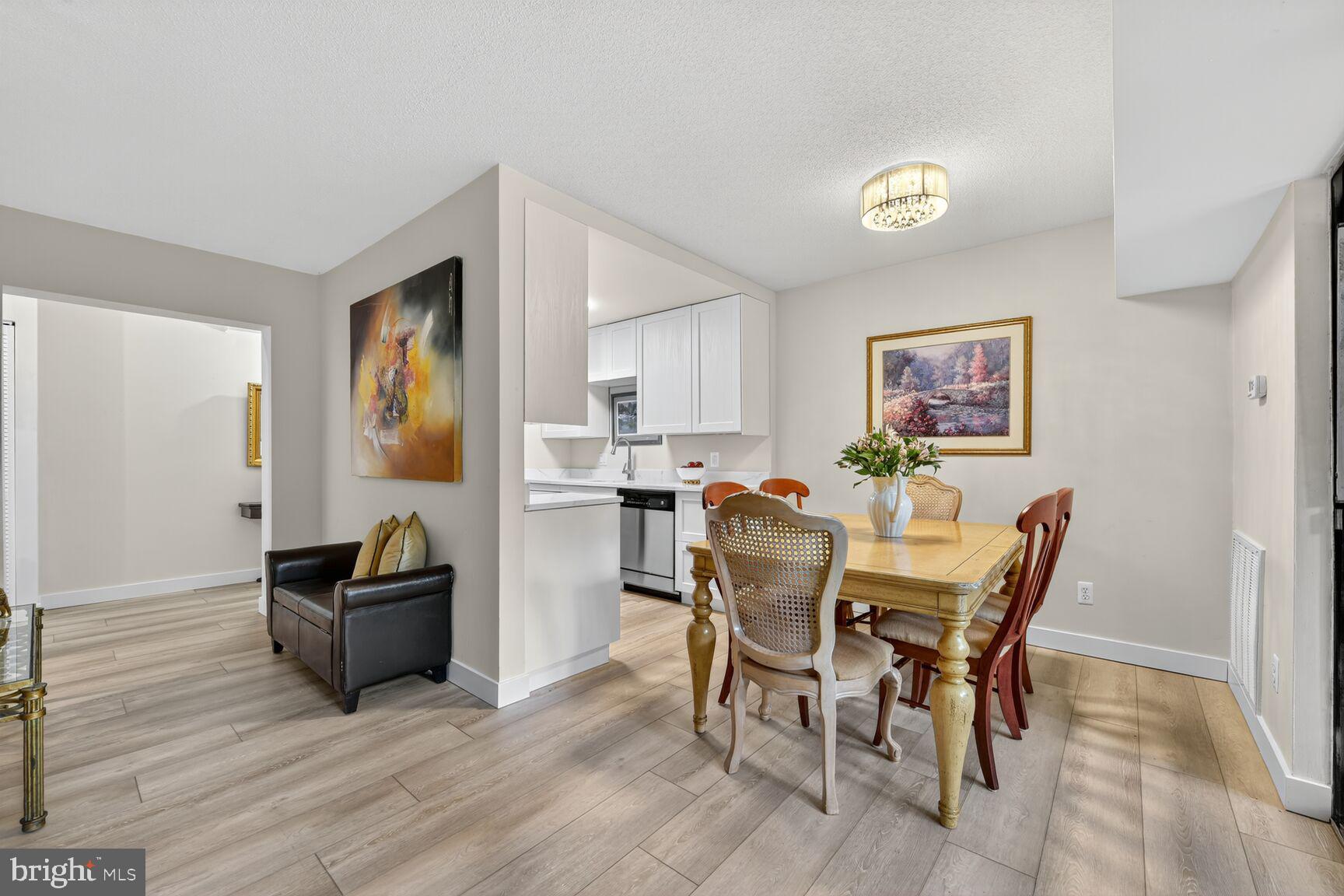 2208 Castle Rock Square, Unit 2B Reston, VA 20191 - Photo 8 of 51 a view of a dining room with furniture and wooden floor