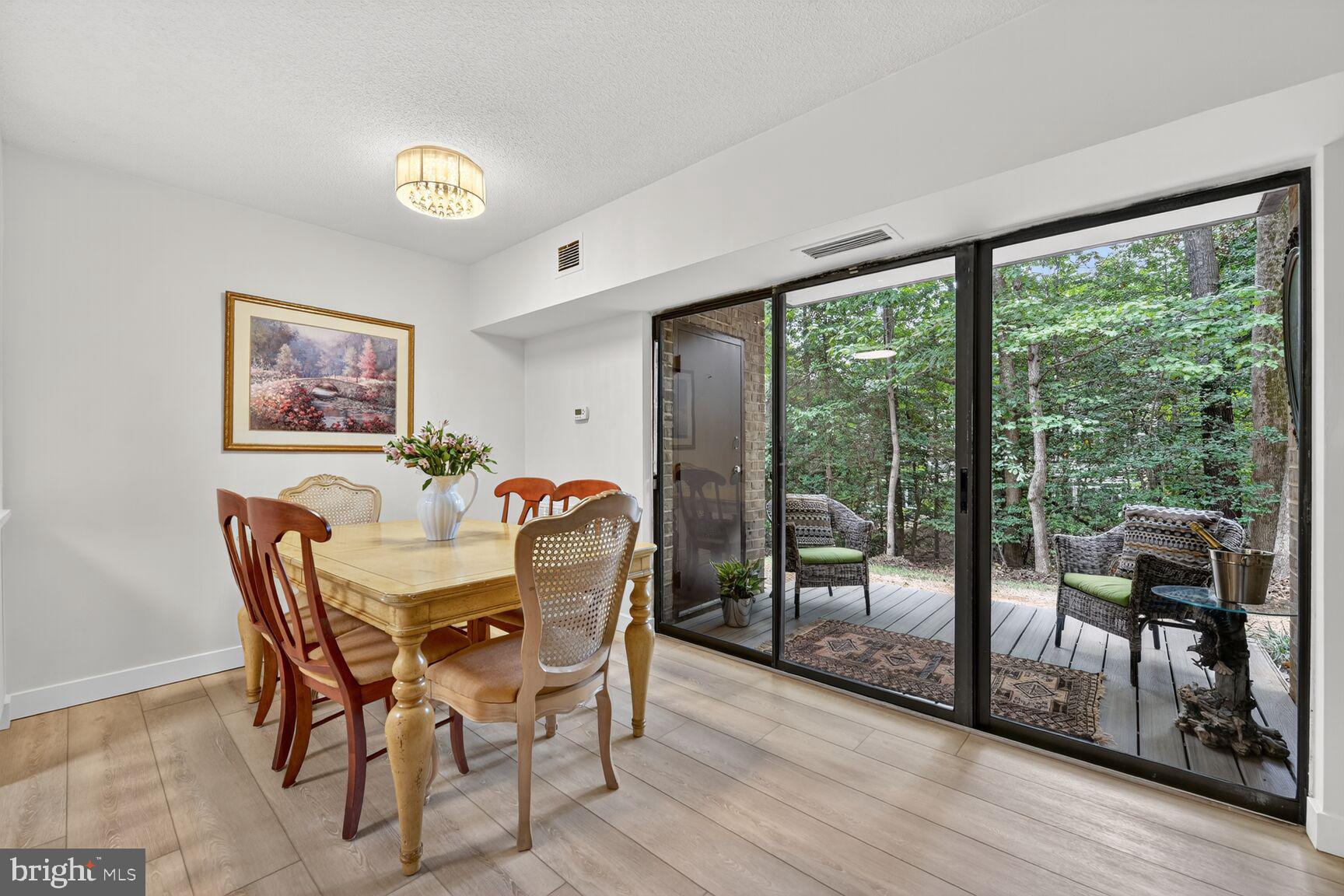 2208 Castle Rock Square, Unit 2B Reston, VA 20191 - Photo 9 of 51 a view of a dining room with furniture large window and wooden floor