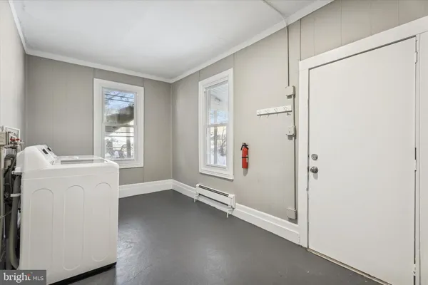 a view of utility room with closet and windows