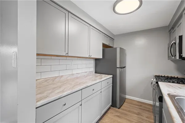 a kitchen with cabinets appliances and a counter space