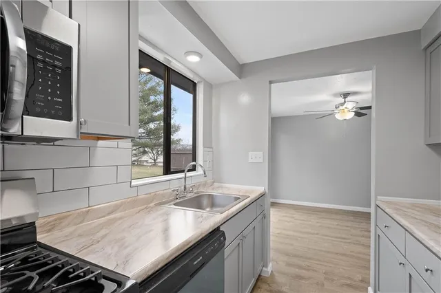 a kitchen with a sink stove and cabinets
