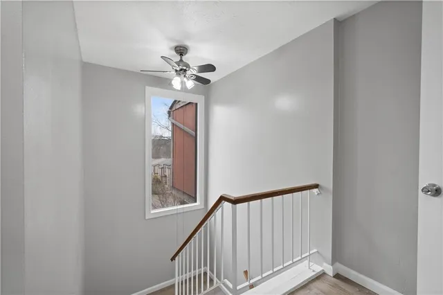 a view of entryway with a chandelier fan