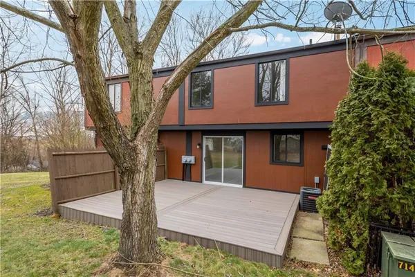 a front view of a house with trees