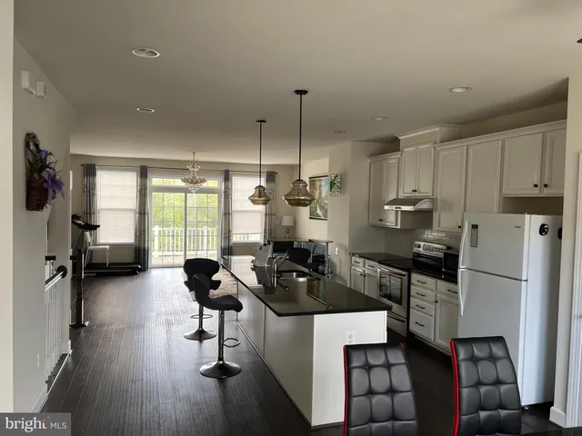 a kitchen with sink refrigerator and window