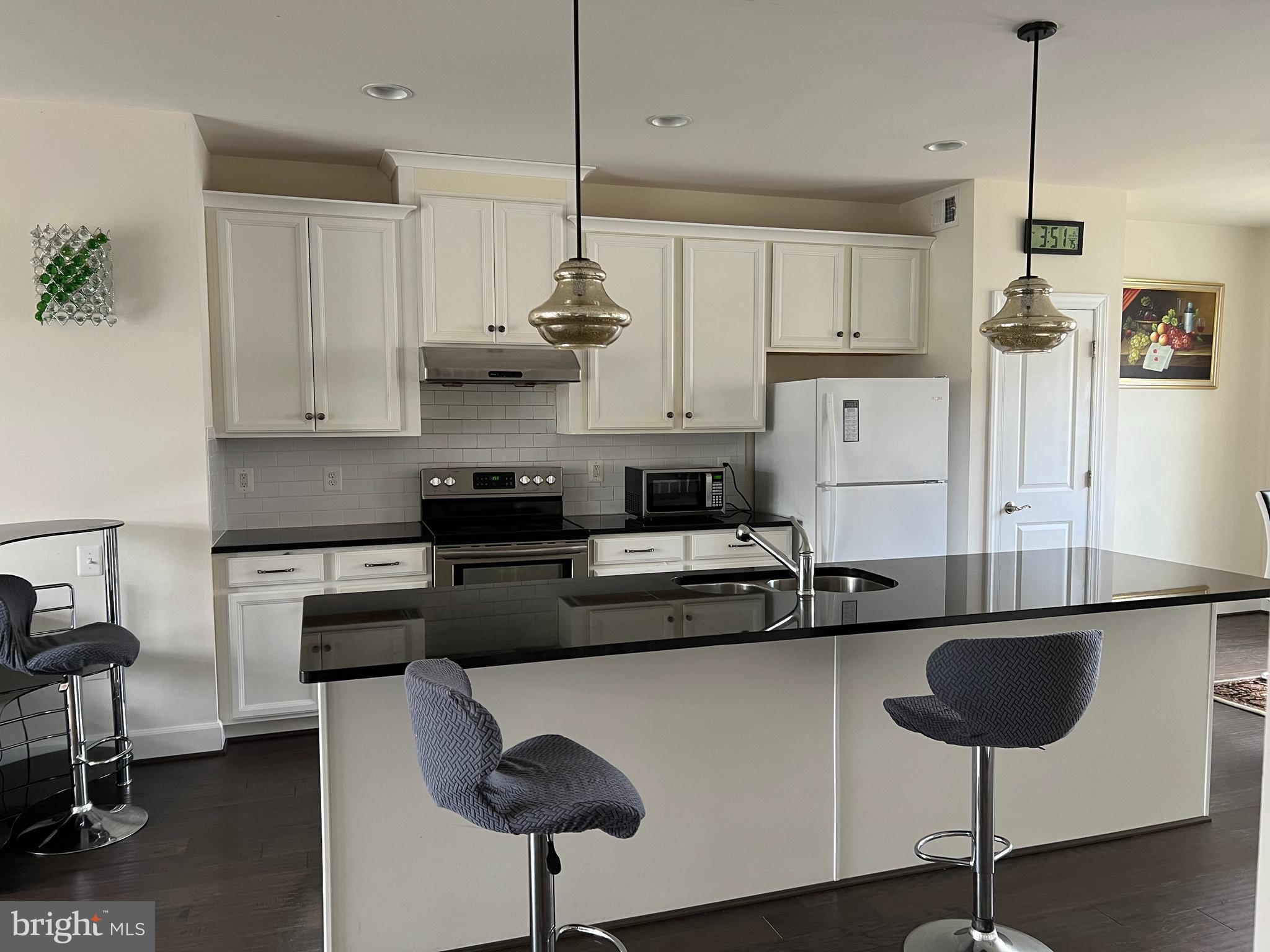 8429 Girvan Court Manassas, VA 20109 - Photo 15 of 31 a kitchen with stainless steel appliances granite countertop a sink a stove and a refrigerator