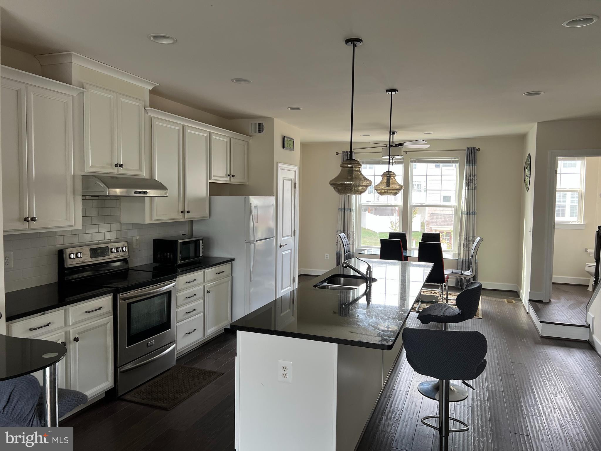 8429 Girvan Court Manassas, VA 20109 - Photo 18 of 31 a kitchen with stainless steel appliances granite countertop a sink a stove and refrigerator