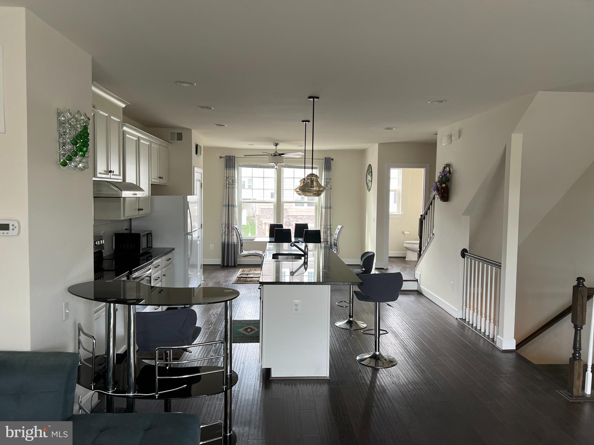 8429 Girvan Court Manassas, VA 20109 - Photo 20 of 31 a view of a dining room with furniture window and wooden floor