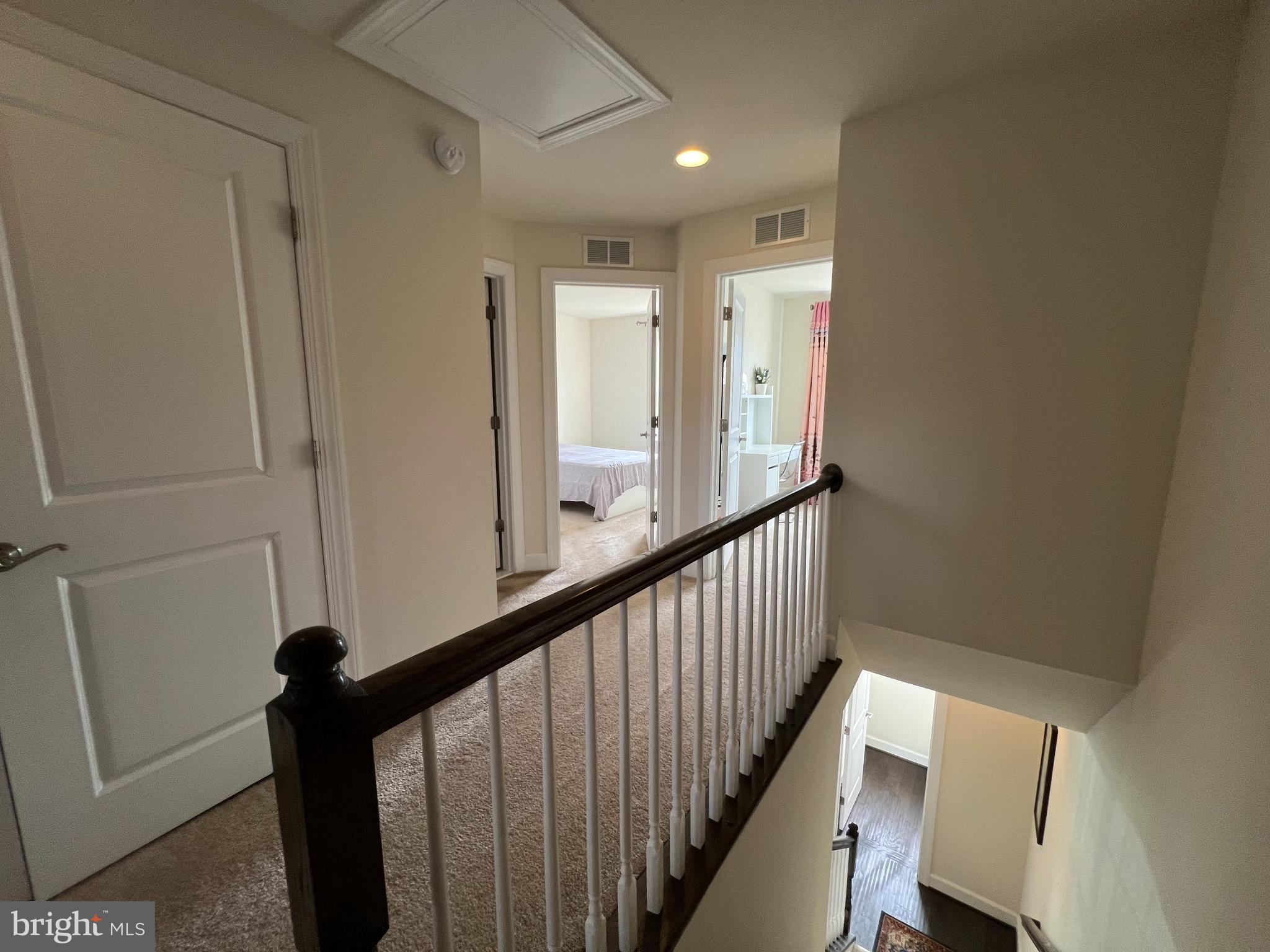 8429 Girvan Court Manassas, VA 20109 - Photo 23 of 31 a view of a hallway with wooden floor and staircase