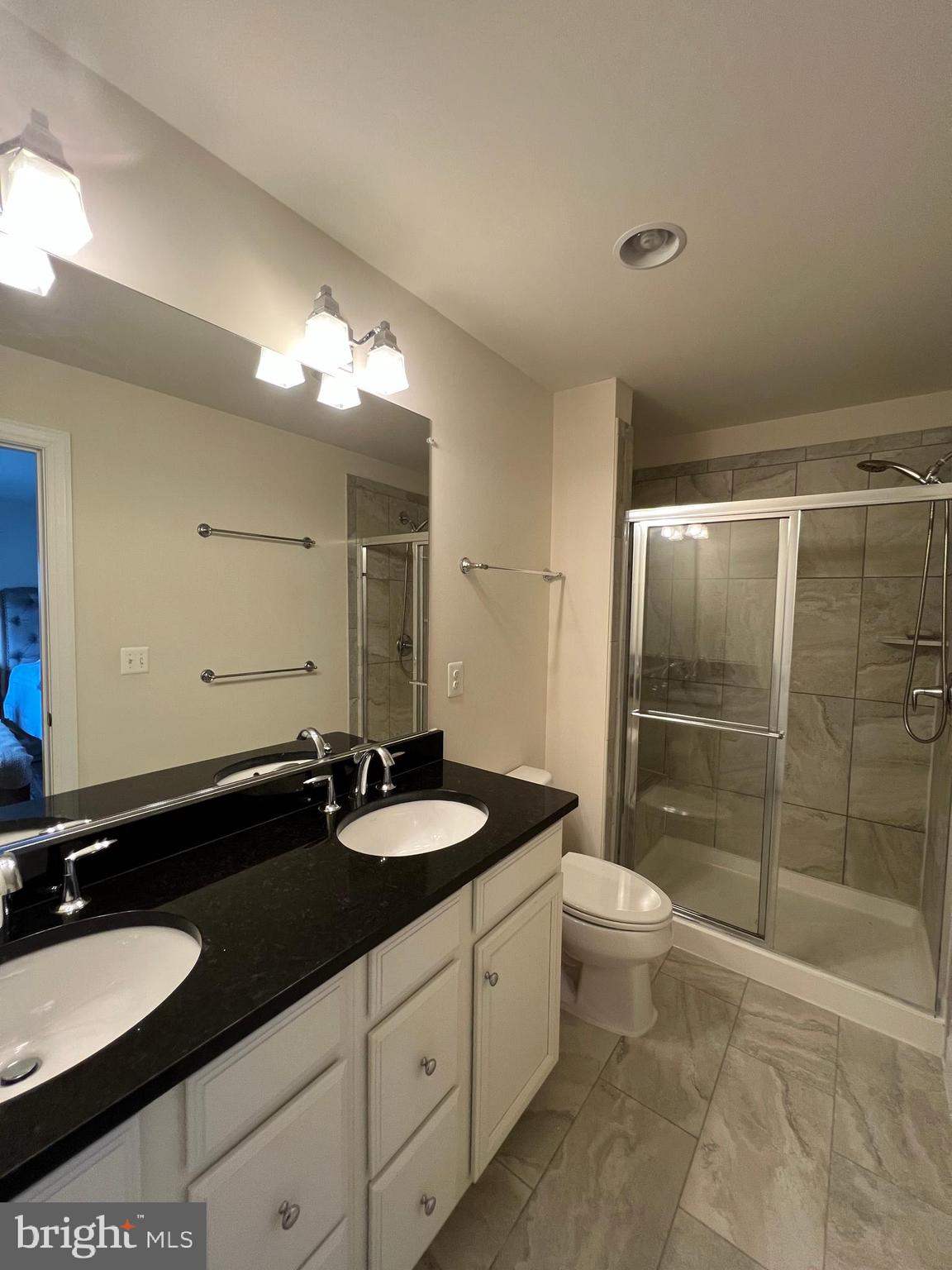 8429 Girvan Court Manassas, VA 20109 - Photo 26 of 31 a bathroom with a double vanity sink toilet and shower