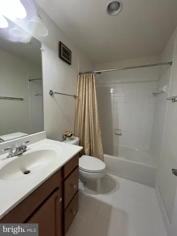 a bathroom with a sink a toilet a mirror and shower
