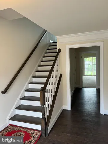 a view of entryway with wooden floor and stairs