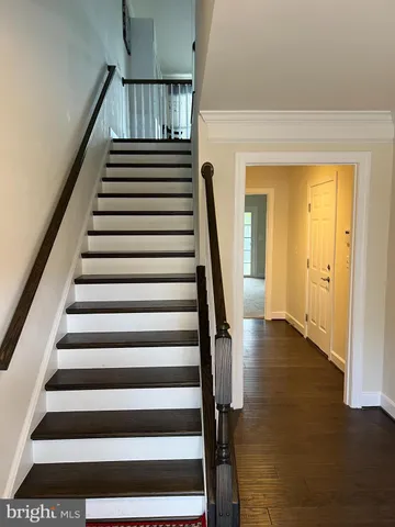 a view of entryway with wooden floor and windows