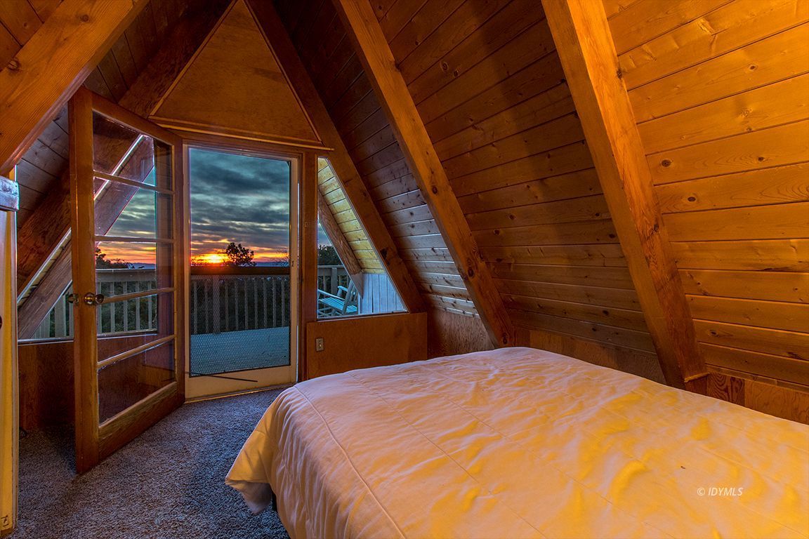 24625 Rocky Point Road Idyllwild, CA 92549 - Photo 25 of 34 a bedroom with a bed and wooden floor