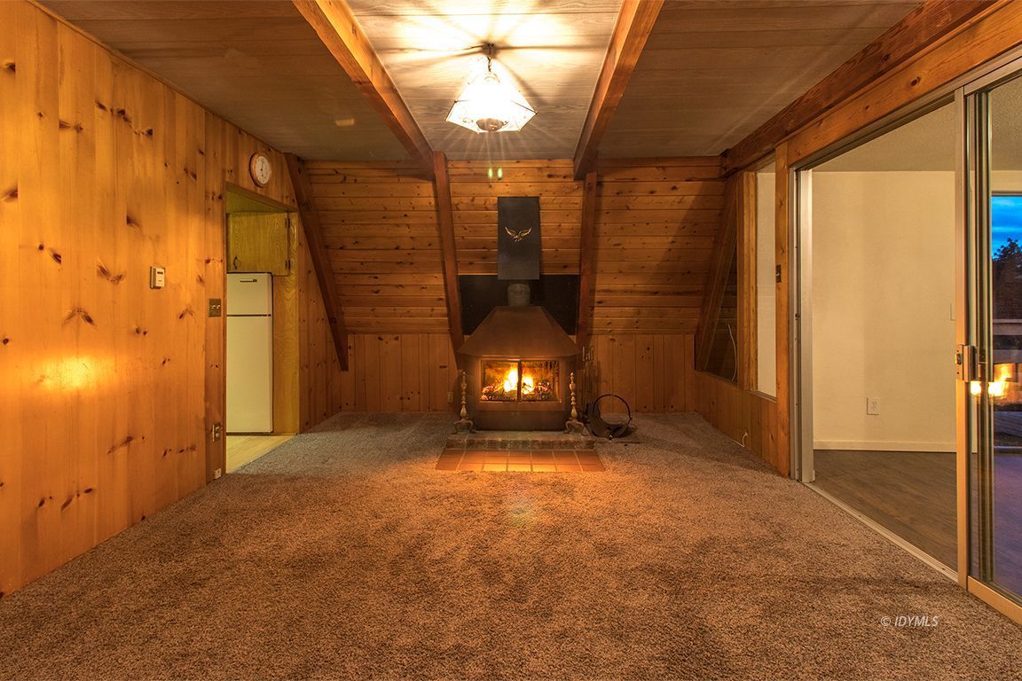 24625 Rocky Point Road Idyllwild, CA 92549 - Photo 7 of 34 a view of an empty room with a fireplace and a window