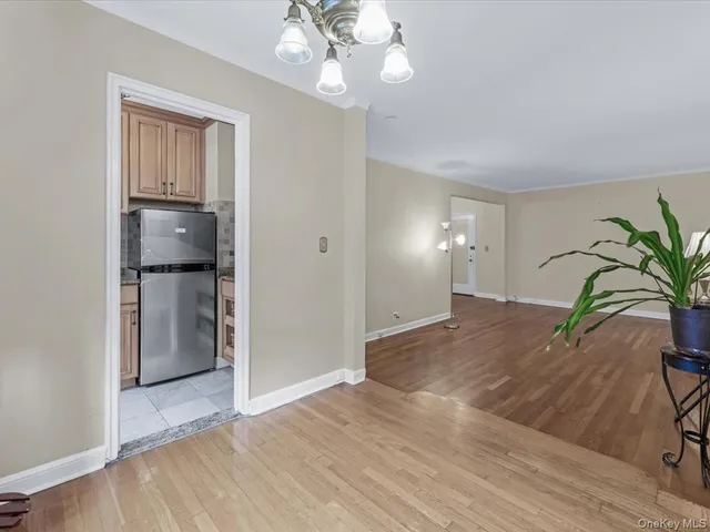 a view of a room with wooden floor and entryway