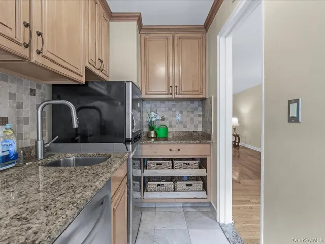 a kitchen with stainless steel appliances granite countertop a sink a stove and cabinets