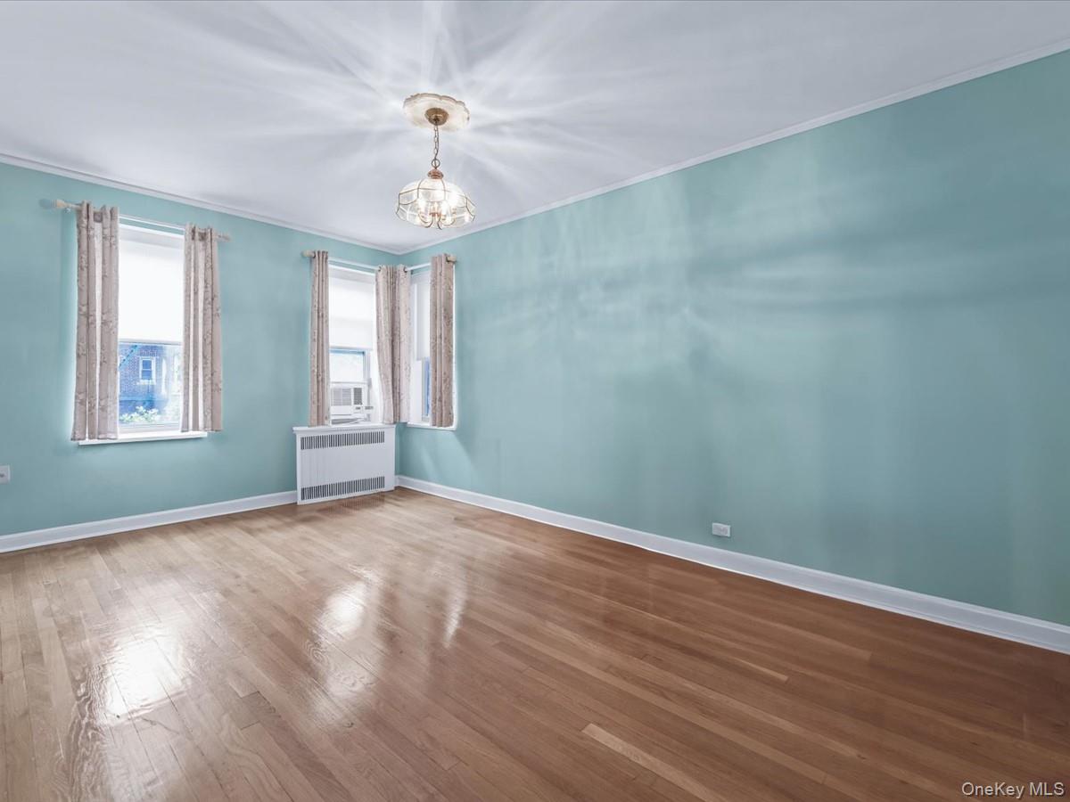11034 73rd Road, Unit 4F Queens, NY 11375 - Photo 15 of 24 wooden floor in an empty room with a window