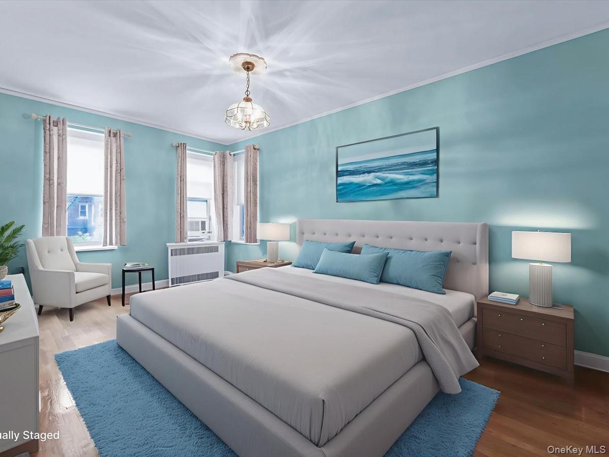 11034 73rd Road, Unit 4F Queens, NY 11375 - Photo 16 of 24 a bedroom with a large bed and a chandelier