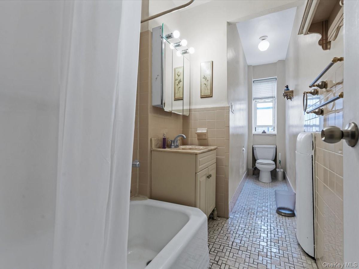 11034 73rd Road, Unit 4F Queens, NY 11375 - Photo 18 of 24 a bathroom with a sink a toilet and shower