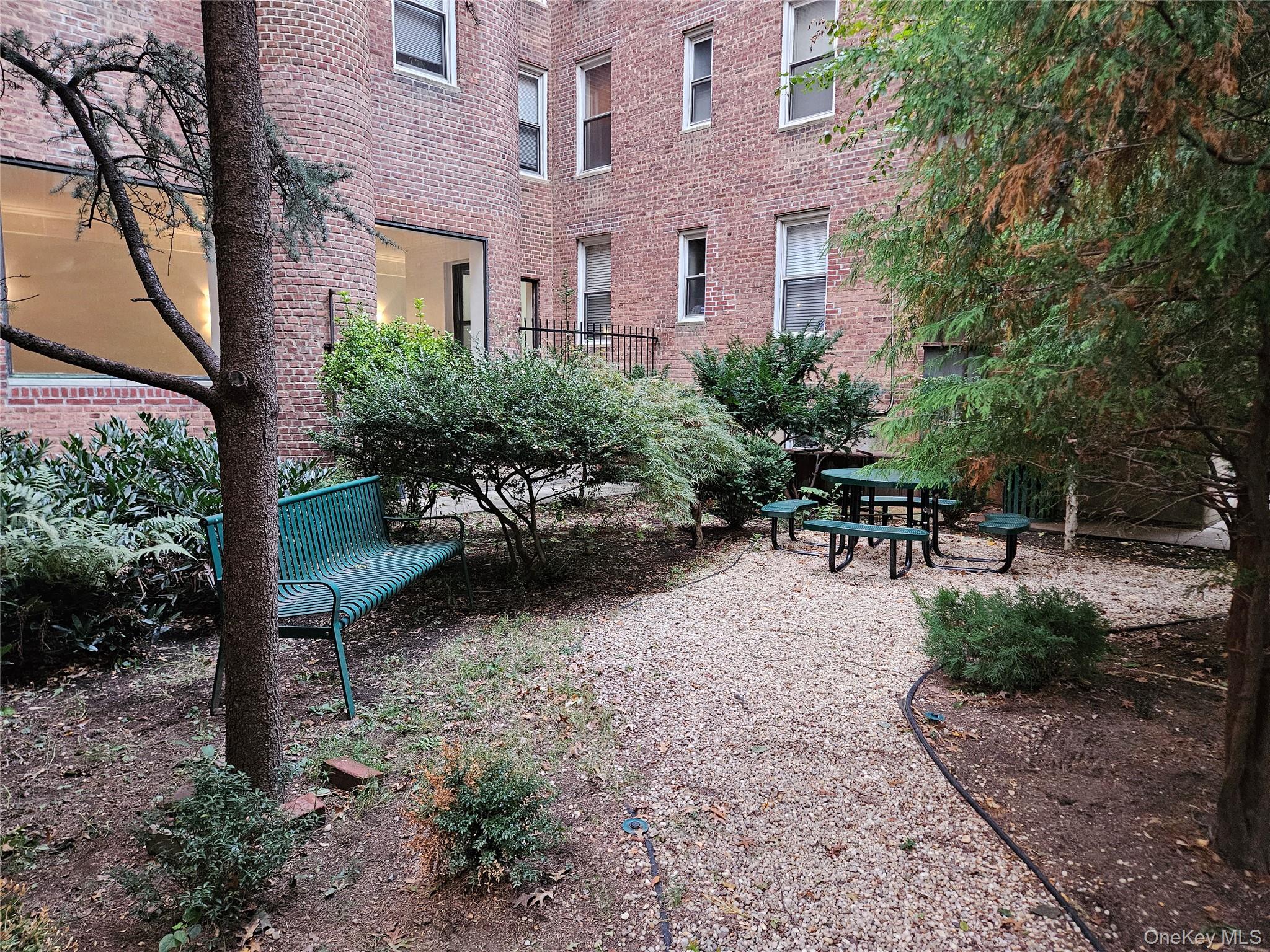 11034 73rd Road, Unit 4F Queens, NY 11375 - Photo 20 of 24 a view of a patio with table and chairs potted plants and a large tree