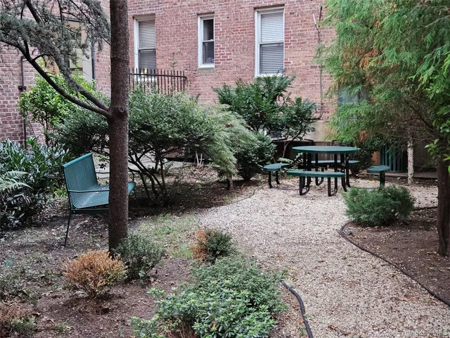 a view of a patio with table and chairs and potted plants
