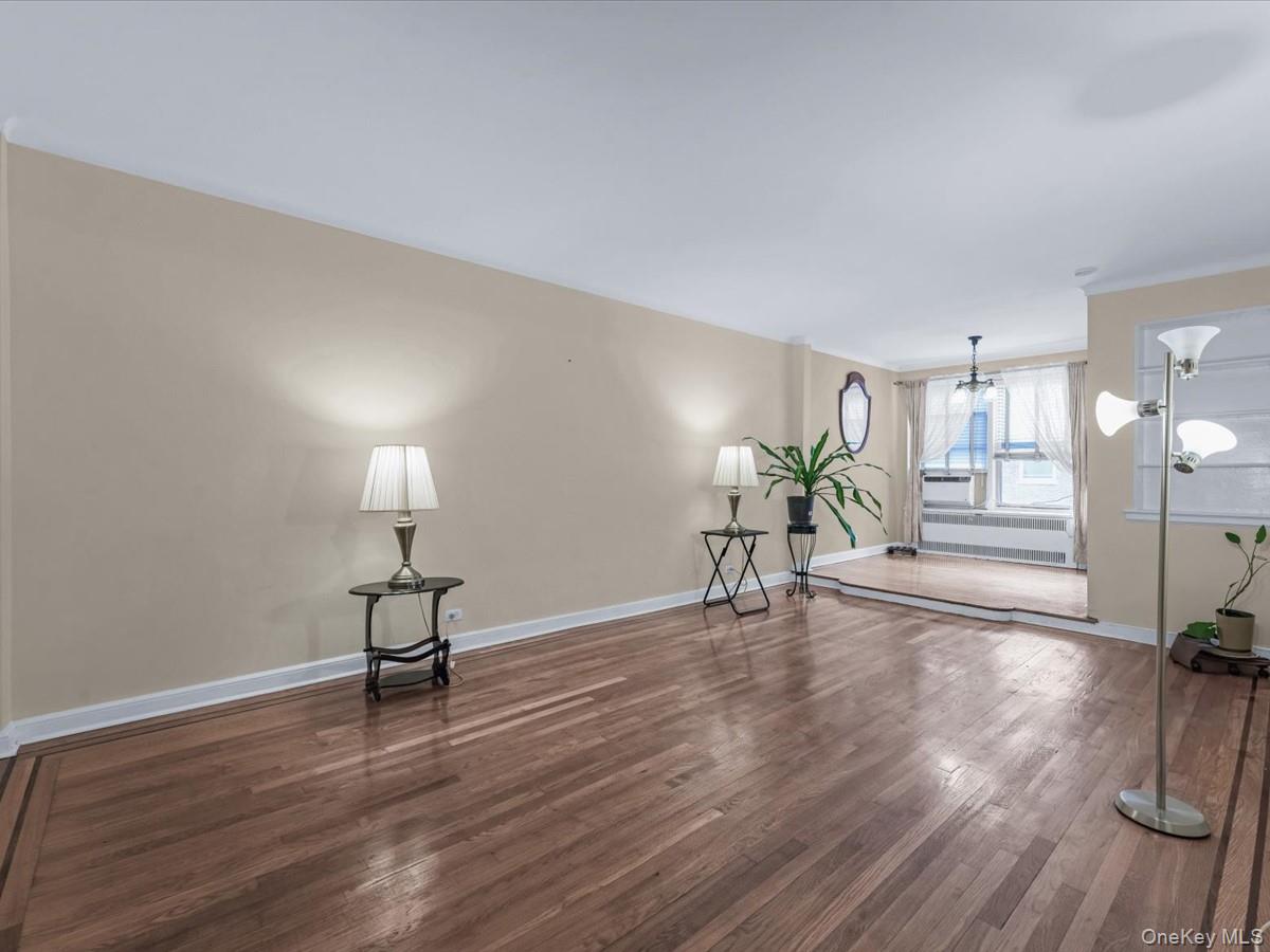 11034 73rd Road, Unit 4F Queens, NY 11375 - Photo 7 of 24 a view of a room with wooden floor table and chairs