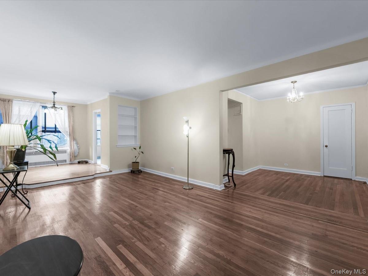 11034 73rd Road, Unit 4F Queens, NY 11375 - Photo 9 of 24 a view of empty room with wooden floor
