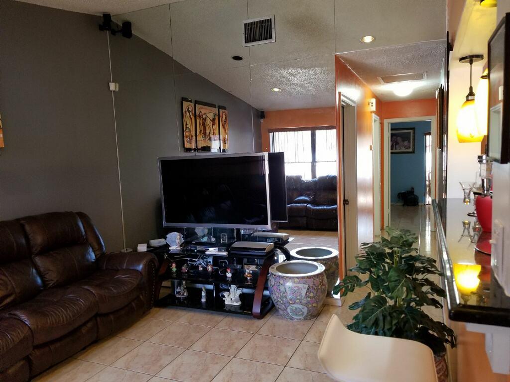 3768 Mil-Stream Court Greenacres, FL 33463 - Photo 11 of 36 a living room with furniture and a flat screen tv