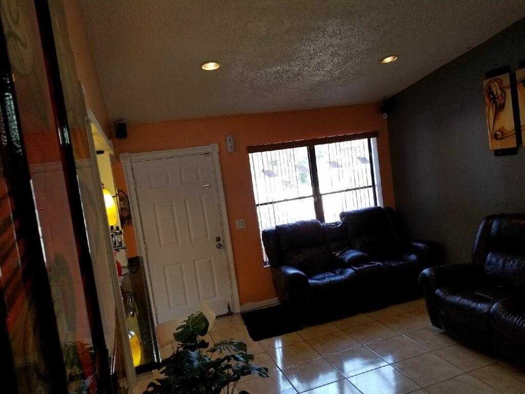 3768 Mil-Stream Court Greenacres, FL 33463 - Photo 12 of 36 a living room with furniture and a window