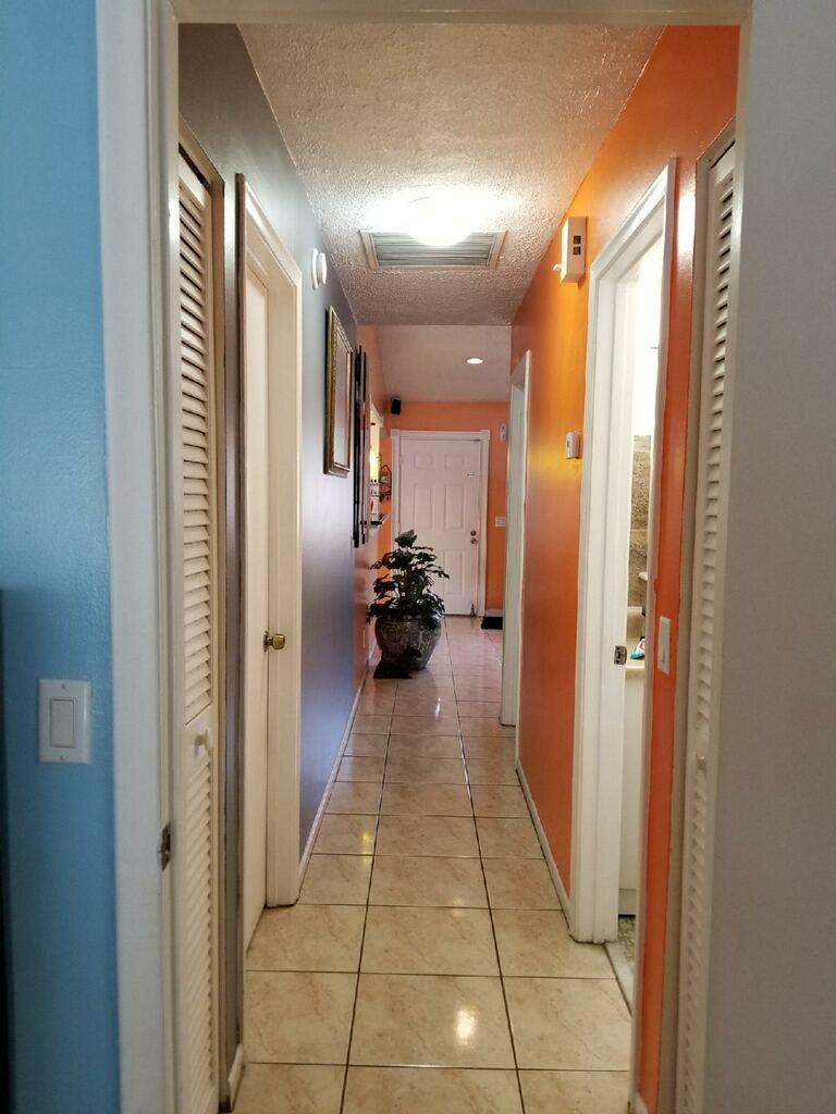 3768 Mil-Stream Court Greenacres, FL 33463 - Photo 13 of 36 a view of a hallway with closet and a bathroom