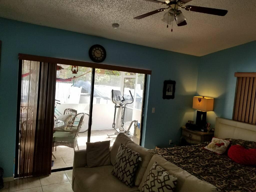 3768 Mil-Stream Court Greenacres, FL 33463 - Photo 14 of 36 a bedroom with furniture and a large window