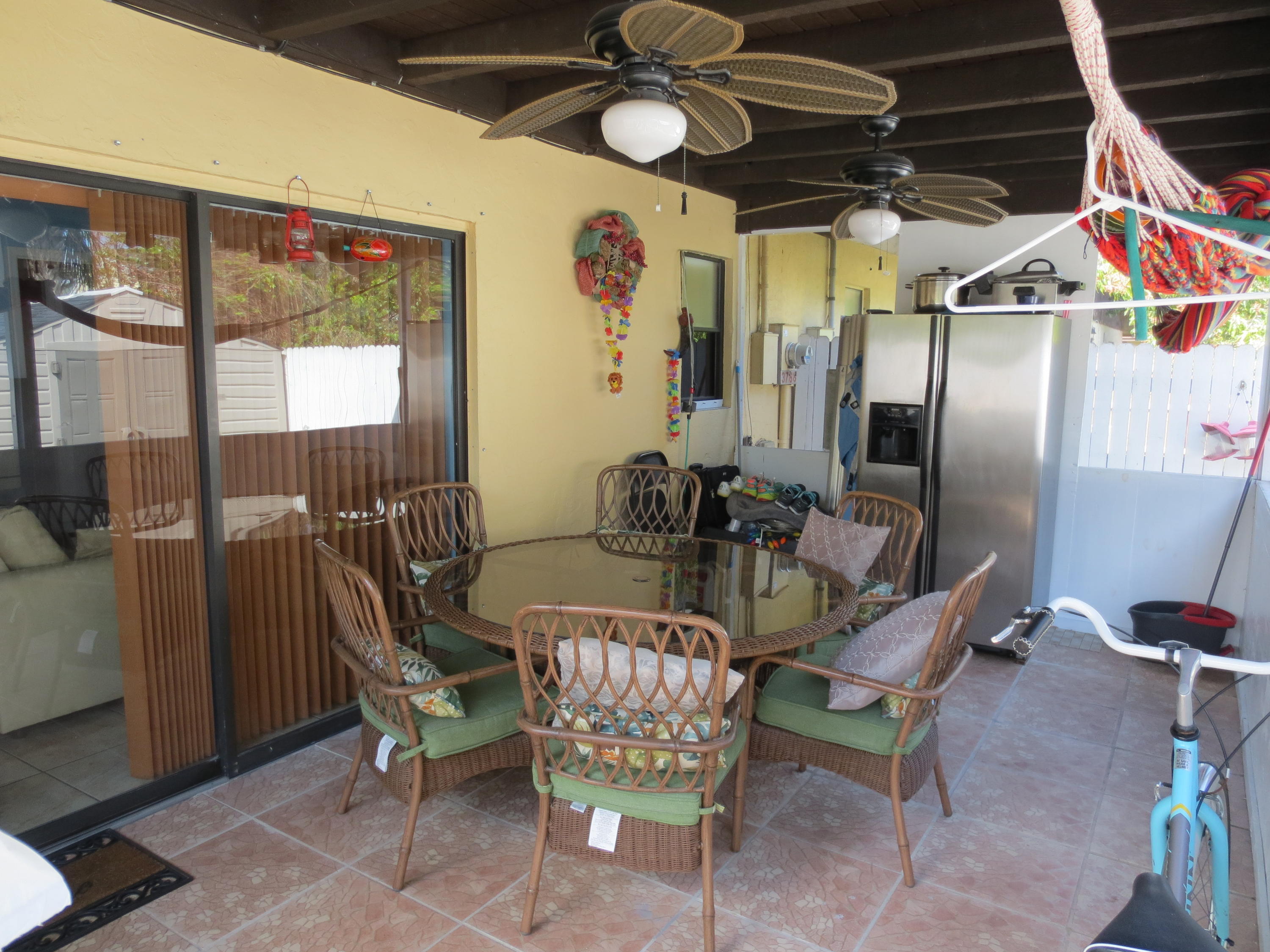 3768 Mil-Stream Court Greenacres, FL 33463 - Photo 17 of 36 a dining room with furniture and a chandelier
