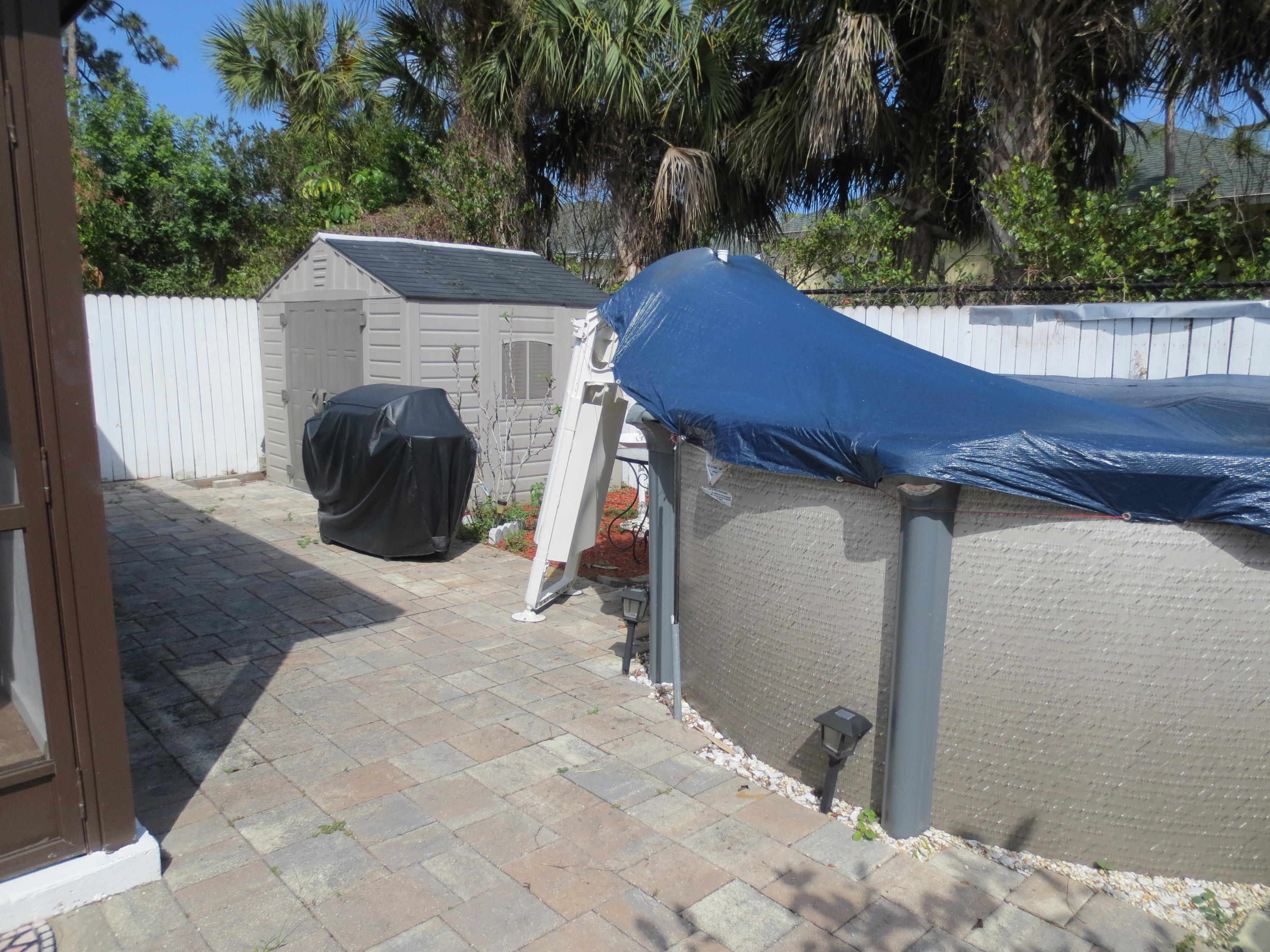 3768 Mil-Stream Court Greenacres, FL 33463 - Photo 20 of 36 a backyard of a house with green space and outdoor seating